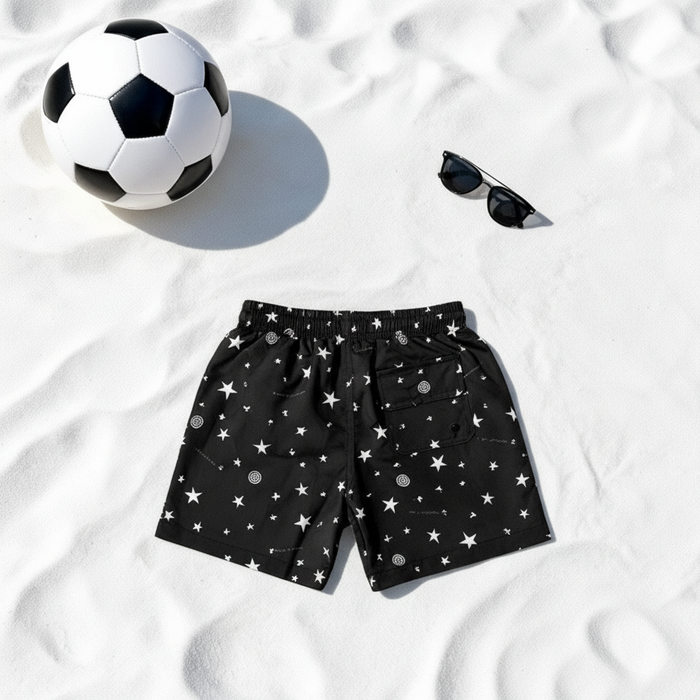 Minimalist flat lay with boy swim shorts in star print